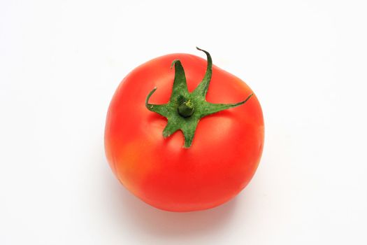 Red tomato shot from above, isolated on white, studio lighting