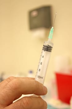 Doctor with a syringe in his hand at hospital