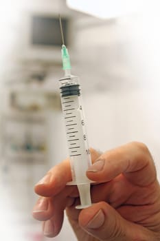 Doctor with a syringe in his hand at hospital