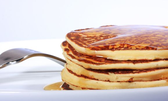 pile of american pancakes with syrup