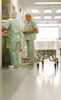 Two nurses talking at the hospital corridor