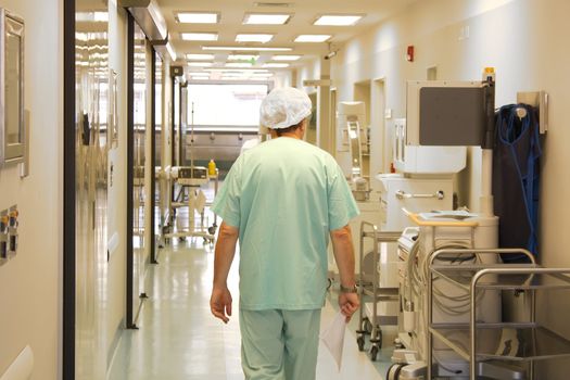 Doctor using srubs walking at the hospital corridor 