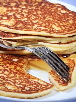 pile of american pancakes with syrup