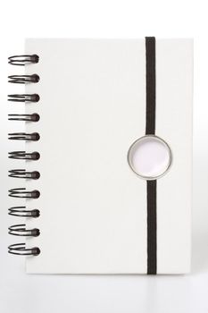 White notebook with black ring binders, isolated on white, black string to hold it closed