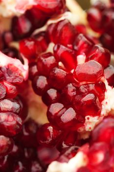 Close up of a red juicy ripe pomegranate seeds