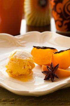 Ice cream and persimmon with anis star on plate