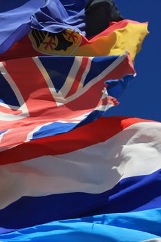 The national flags of France, UK and Germany  all flying together, thight shot. 