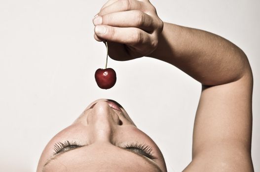 Upper View Closeup Of A Woman Sensually Tasting A Cherry