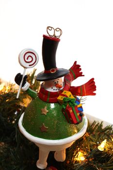 A decorative christmas snowman, white background and christmas lights