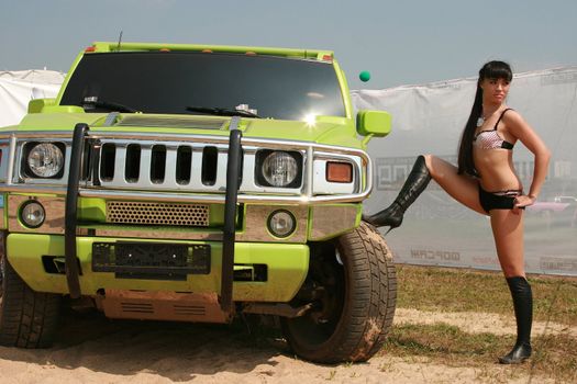 The sexual girl poses near to the smart car