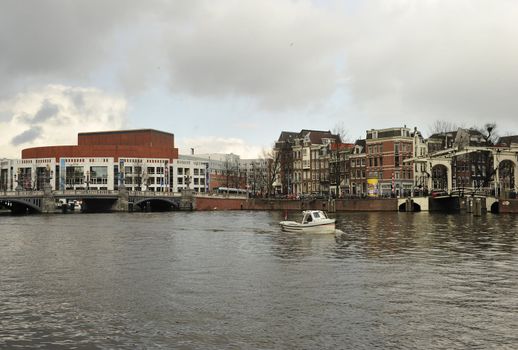 Dutch bridge at Waterlooplein Amsterdam, ship moving on Amstel