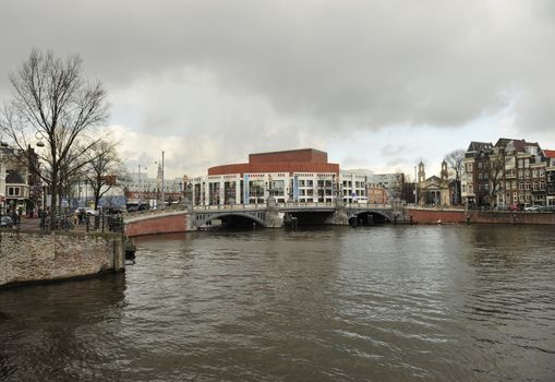 Dutch bridge at Waterlooplein Amsterdam under dark cloudy sky