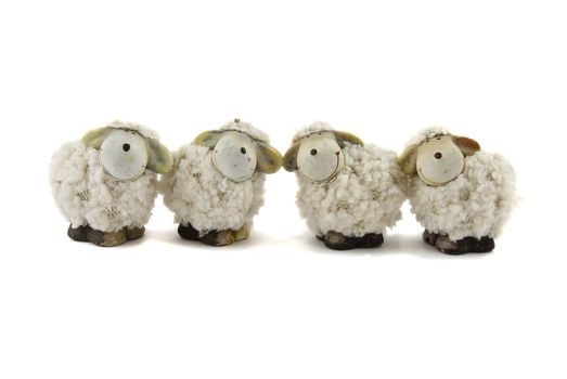 Four sheep toy isolated on the white background.