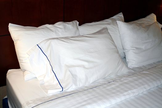 A hotel bed with clean white linens.