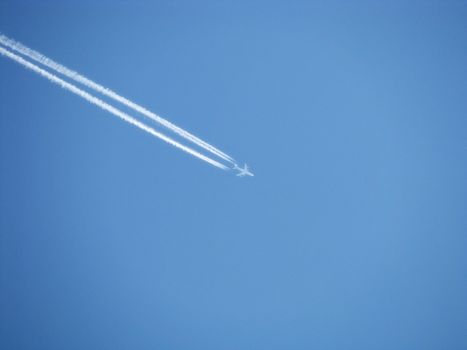 The plane on a background of the blue sky