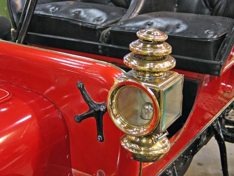 Details of a beautiful red antique car brass lamp 