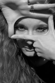 Beautiful girl making signs with hands, black and white image