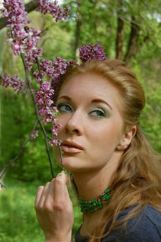 Beautiful girl with lilac blossom