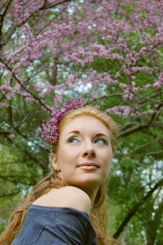 Beautiful girl with lilac blossom