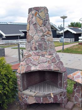 Outdoors rustic fireplace grill made of natural stones