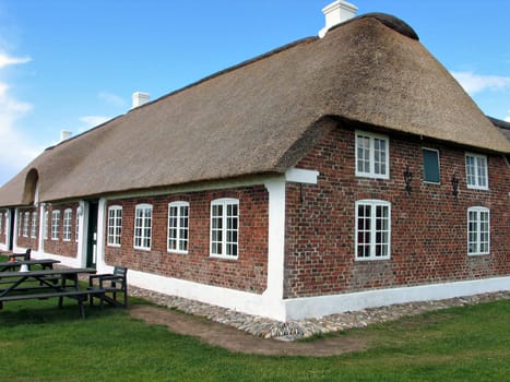 Typical country farmhouse with old style thatched straw roof in Denmark