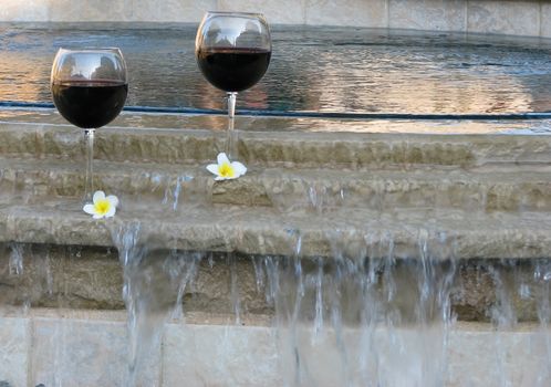 Set for a "staycation" with wine and plumeria petals in the backyard pool and suana.
