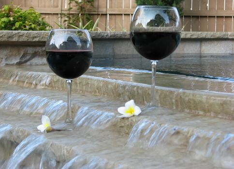 Set for a "staycation" with wine and plumeria petals in the backyard pool and suana.
