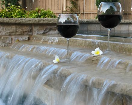 Set for a "staycation" with wine and plumeria petals in the backyard pool and suana.
