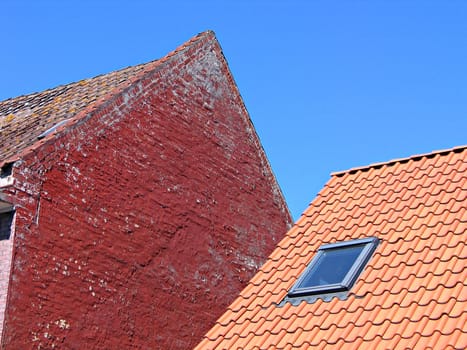 Roofs, tiles and old rustic bricks wall 