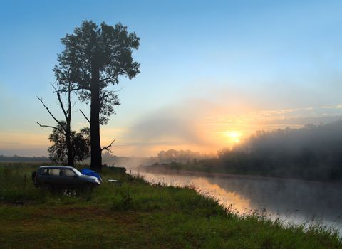 fog sunrise on the river with camping