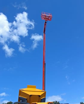 Crane with hydraulic boom up with sky background