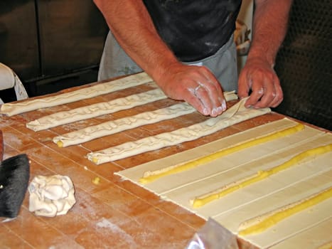 Baker with tray of cakes just before going into the oven