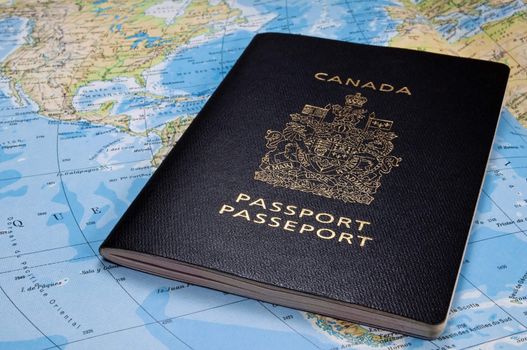 Photo of a Canadian passport on map.