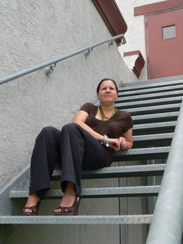 Attractive brunette woman sitting on steps