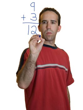 A young man doing simple math with a marker