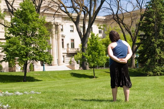 A female tourist taking in the view of a large historic building