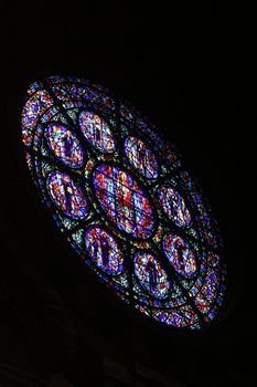 A rose window of a catholic church from the inside.