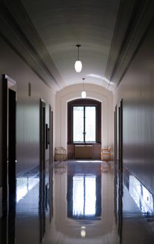 An empty hallway with reflections on the floor