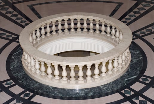 A wishing well made of marble located on a floor made of marble