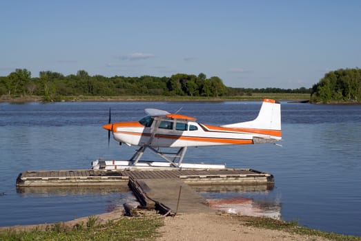 A small water plane docked at the pier