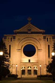 An old monastery lit by street lights at night