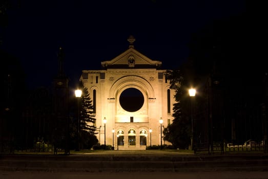 An empty monastery shot on a dark night, lit by lights