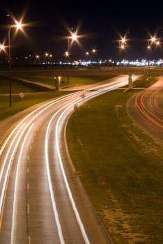 Traffic blurs on a busy highway, shot at night