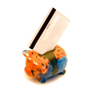 A debit card sitting in a painted piggy bank