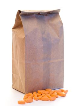A paper lunch bag with pills, isolated on a white background