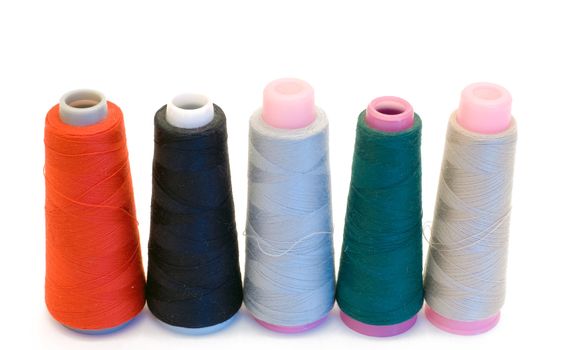 Five large spools of thread isolated on a white background