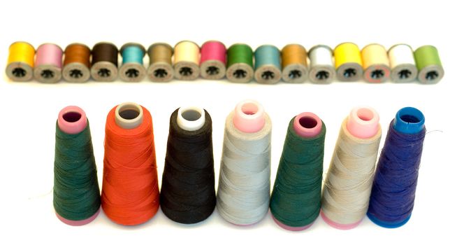 Various sizes and colors of thread isolated on a white background