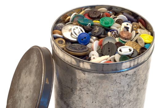 A large tin can full of sewing buttons, isolated on a white background