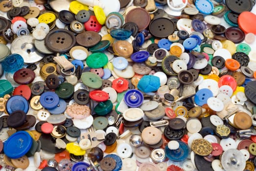 Background of multicolored sewing buttons of assorted sizes