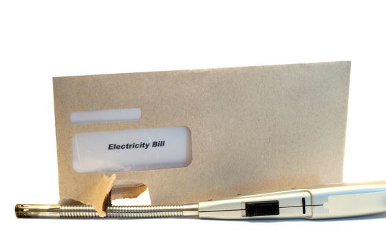 An electric bill in an envelope with a light beside it